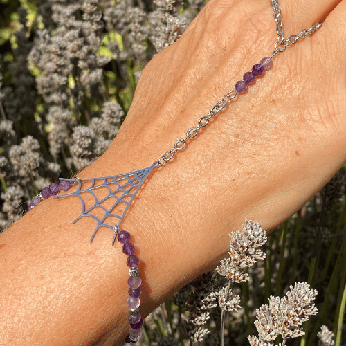 Bracelet (bijoux de main composé d'un bracelet qui s'accroche également sur le majeur) sur le thème Halloween avec une breloque argent représentant une toile d'araignée, composé d'améthyste - vue de face