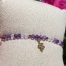 Bracelet bohème fait main en améthyste et cristal de roche, monté sur fil violet avec apprêts dorés et breloque serpent, signé Les Merveilles by Pauline.