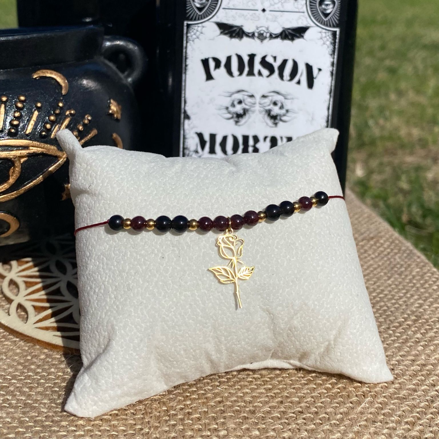 Bracelet inspiré de Morticia Addams, fait main en grenat et obsidienne noire, orné d’une breloque rose dorée. Bijou mystique et sensuel, symbole de féminité, de force et d’élégance ténébreuse. Inspiré par la série Netflix Wednesday et le film La famille Addams.