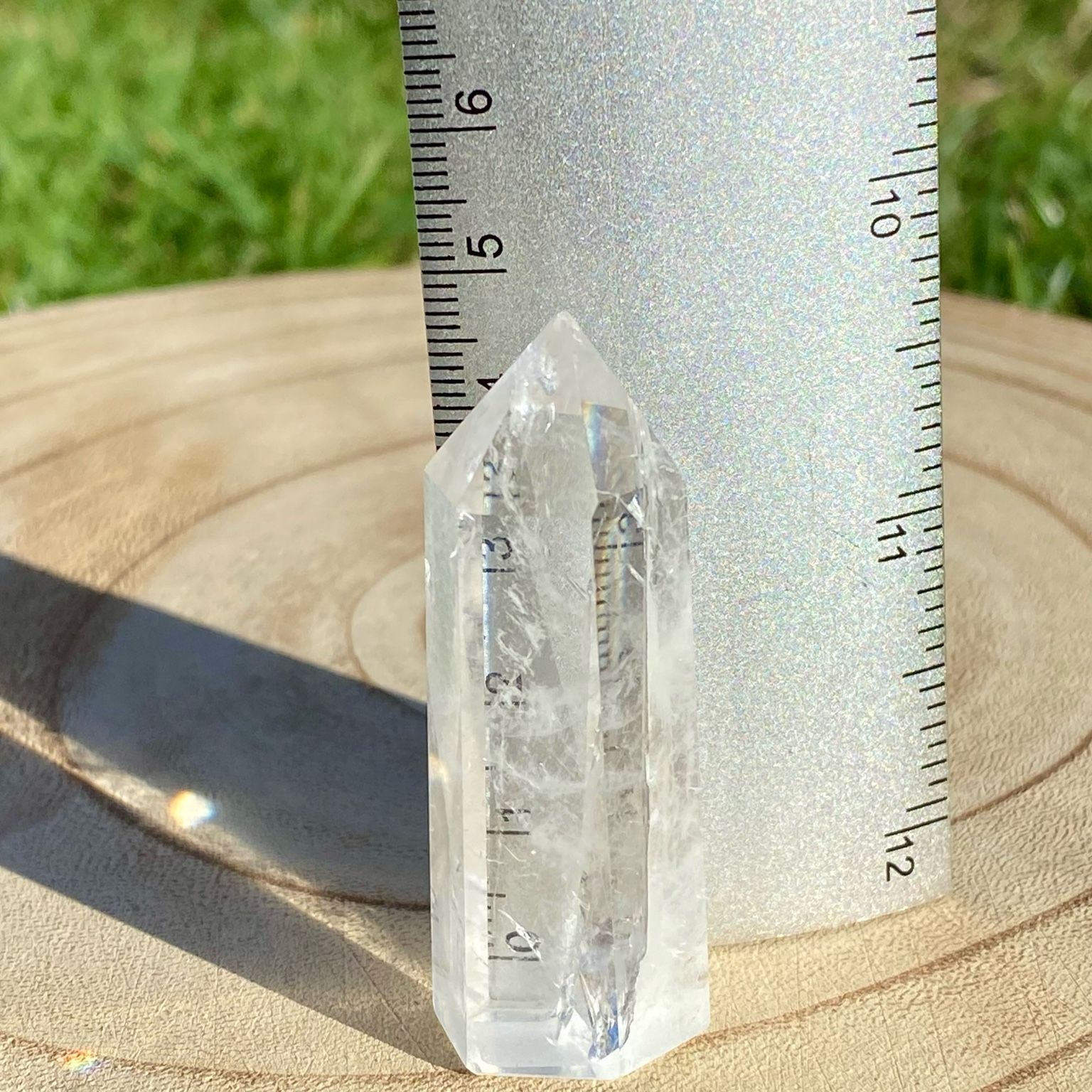 Pointe de cristal de roche translucide naturelle, pierre claire et lumineuse symbolisant la pureté et la clarté énergétique.