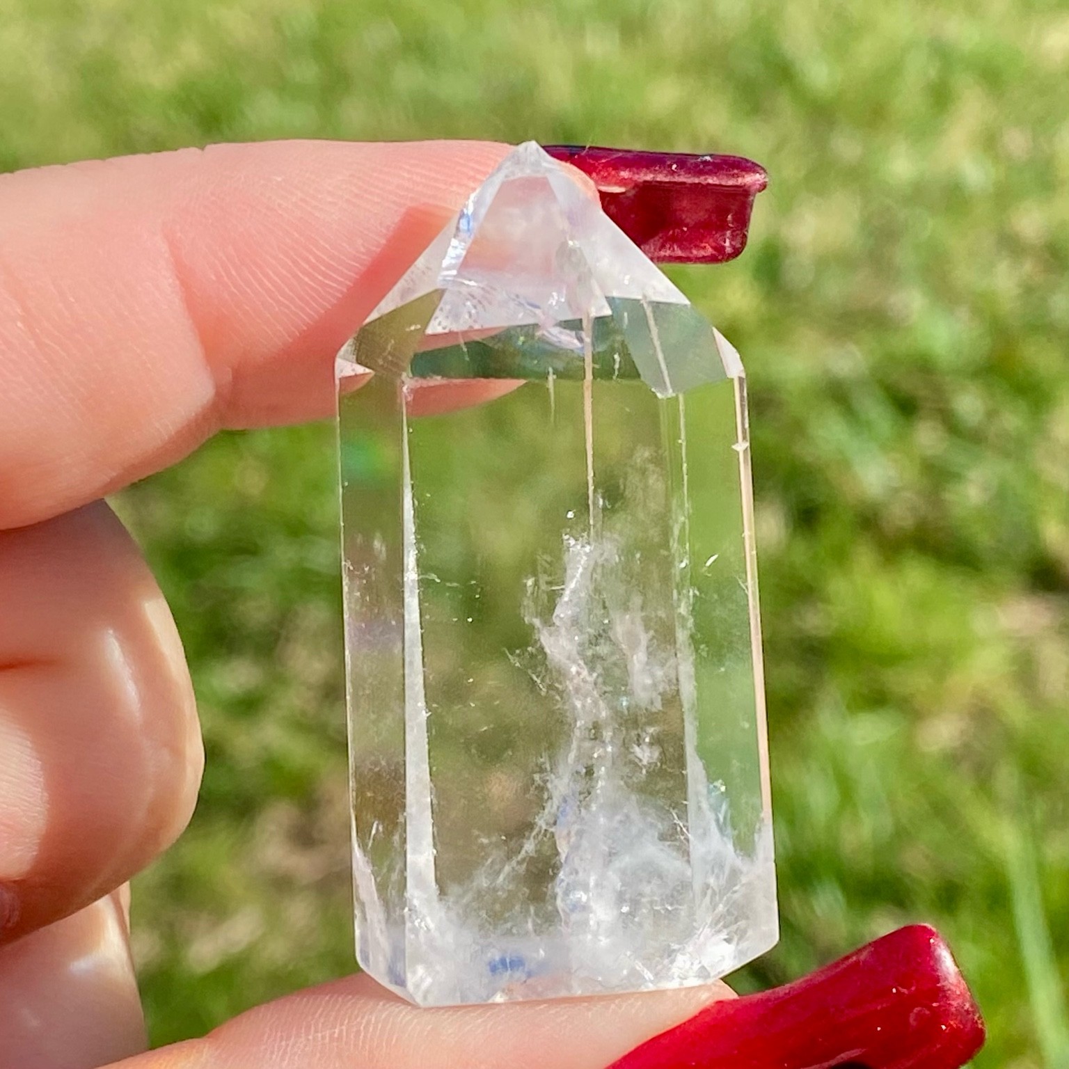 Pointe de cristal de roche translucide naturelle, pierre claire et lumineuse symbolisant la pureté et la clarté énergétique. Les merveilles by Pauline, lithothérapie.